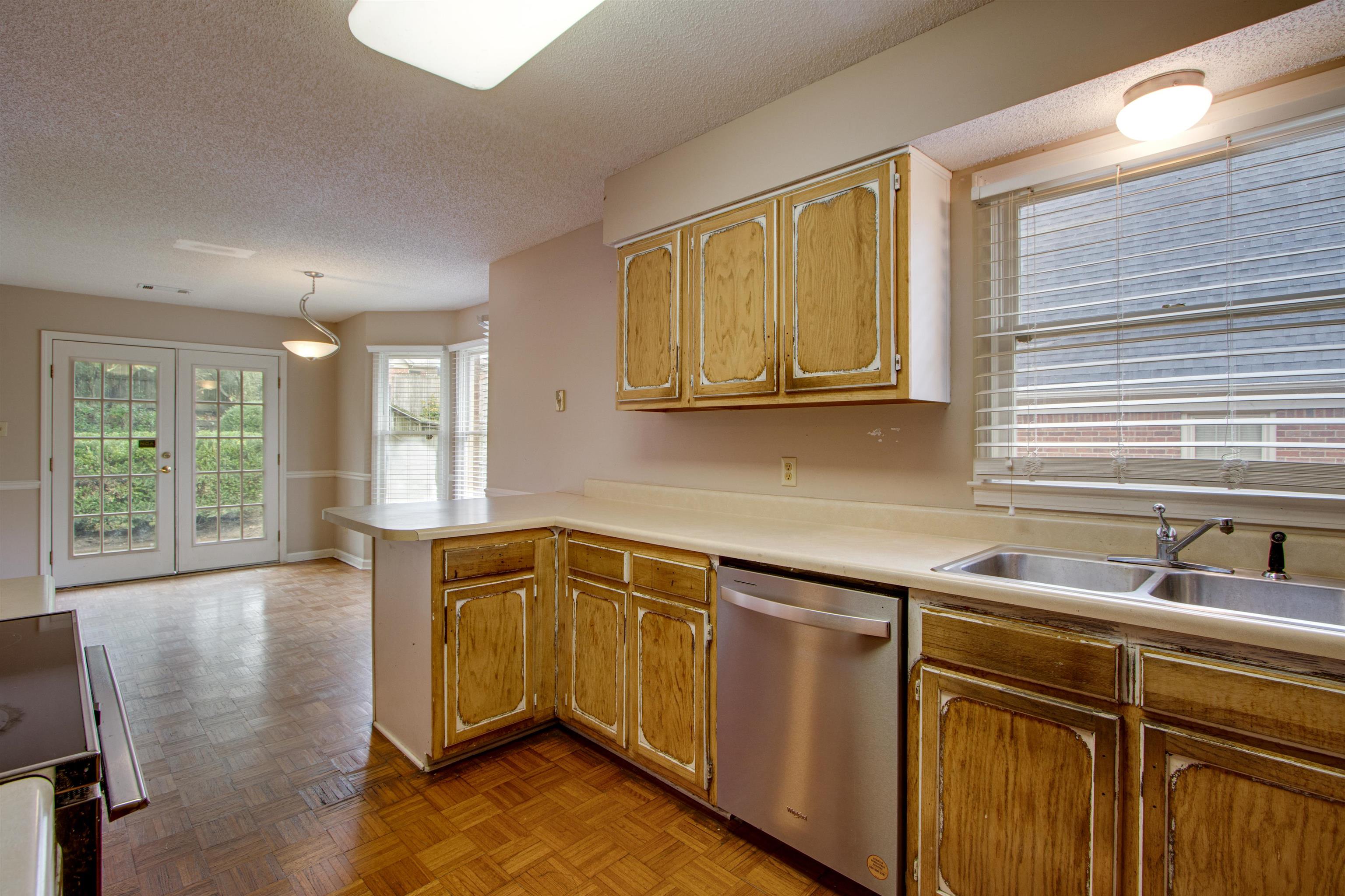 690 Ridge Fall Drive Memphis, TN 38018 - Photo 13 of 28 a kitchen with stainless steel appliances granite countertop a sink a stove cabinets and wooden floor