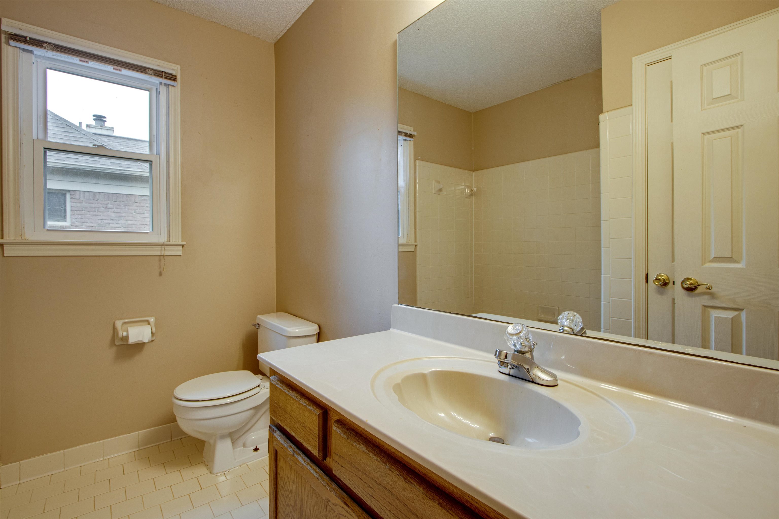 690 Ridge Fall Drive Memphis, TN 38018 - Photo 19 of 28 a bathroom with a granite countertop sink toilet and a mirror