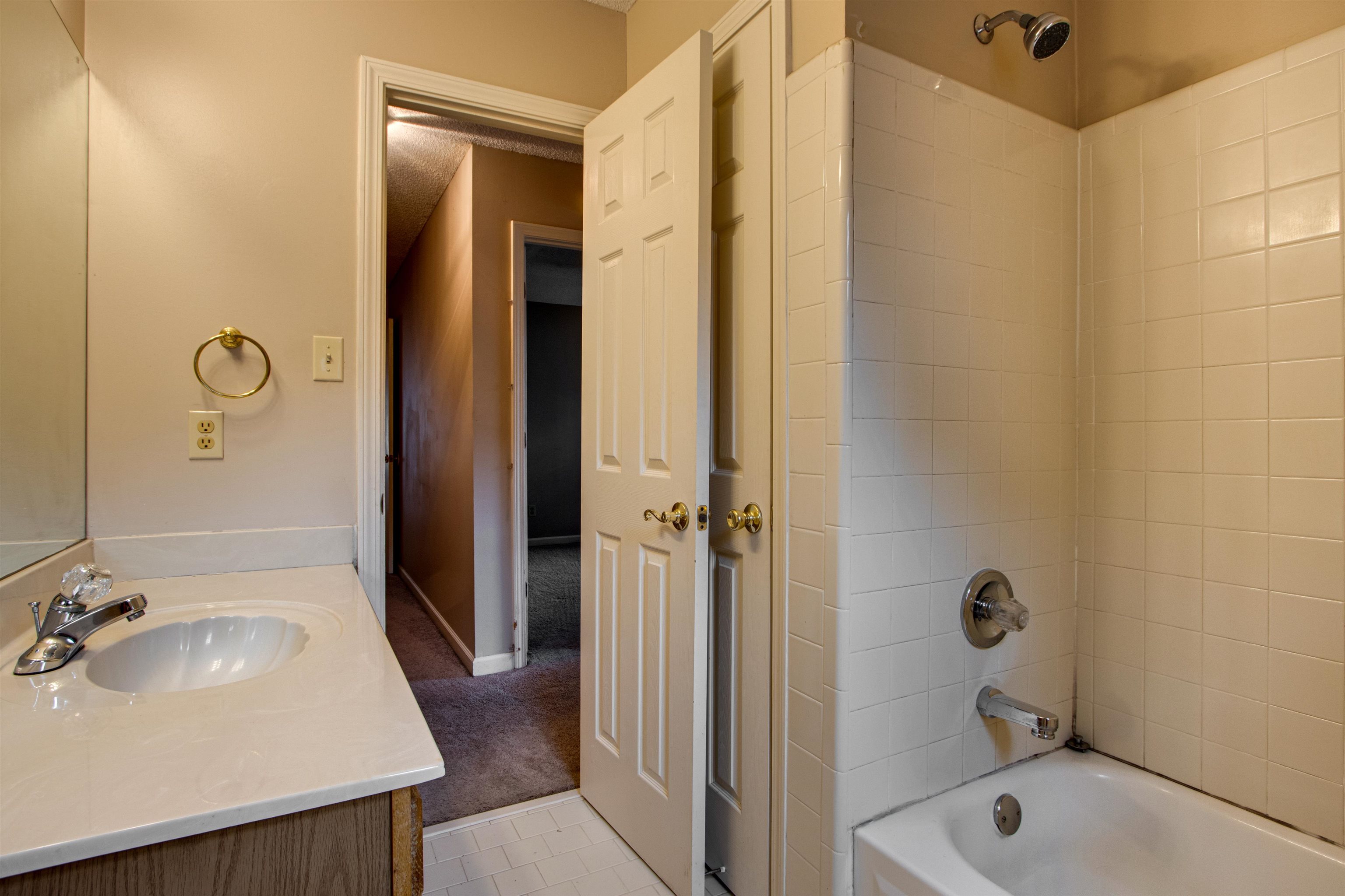 690 Ridge Fall Drive Memphis, TN 38018 - Photo 20 of 28 a bathroom with a tub sink vanity granite and shower