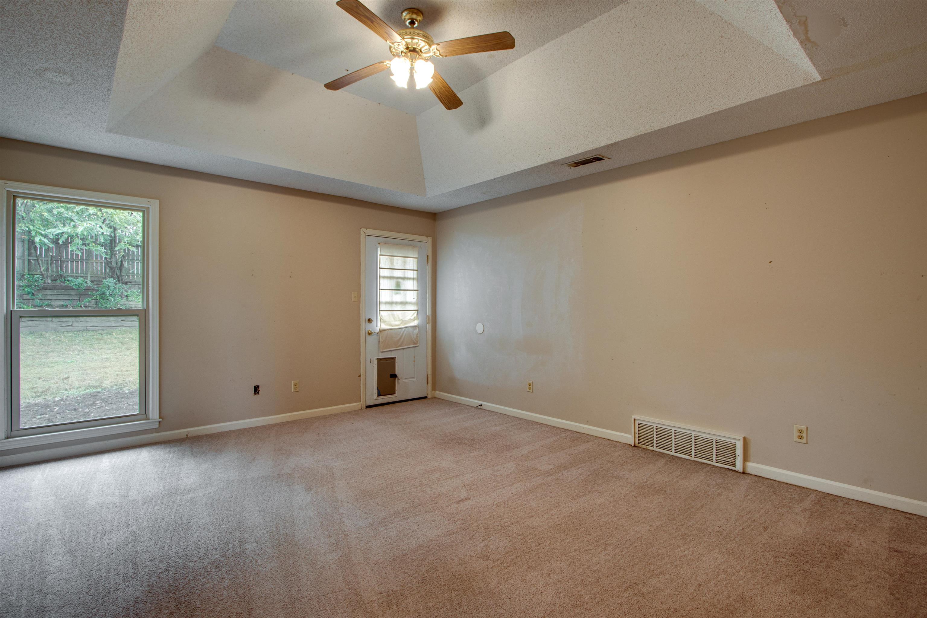 690 Ridge Fall Drive Memphis, TN 38018 - Photo 21 of 28 an empty room with windows and fan