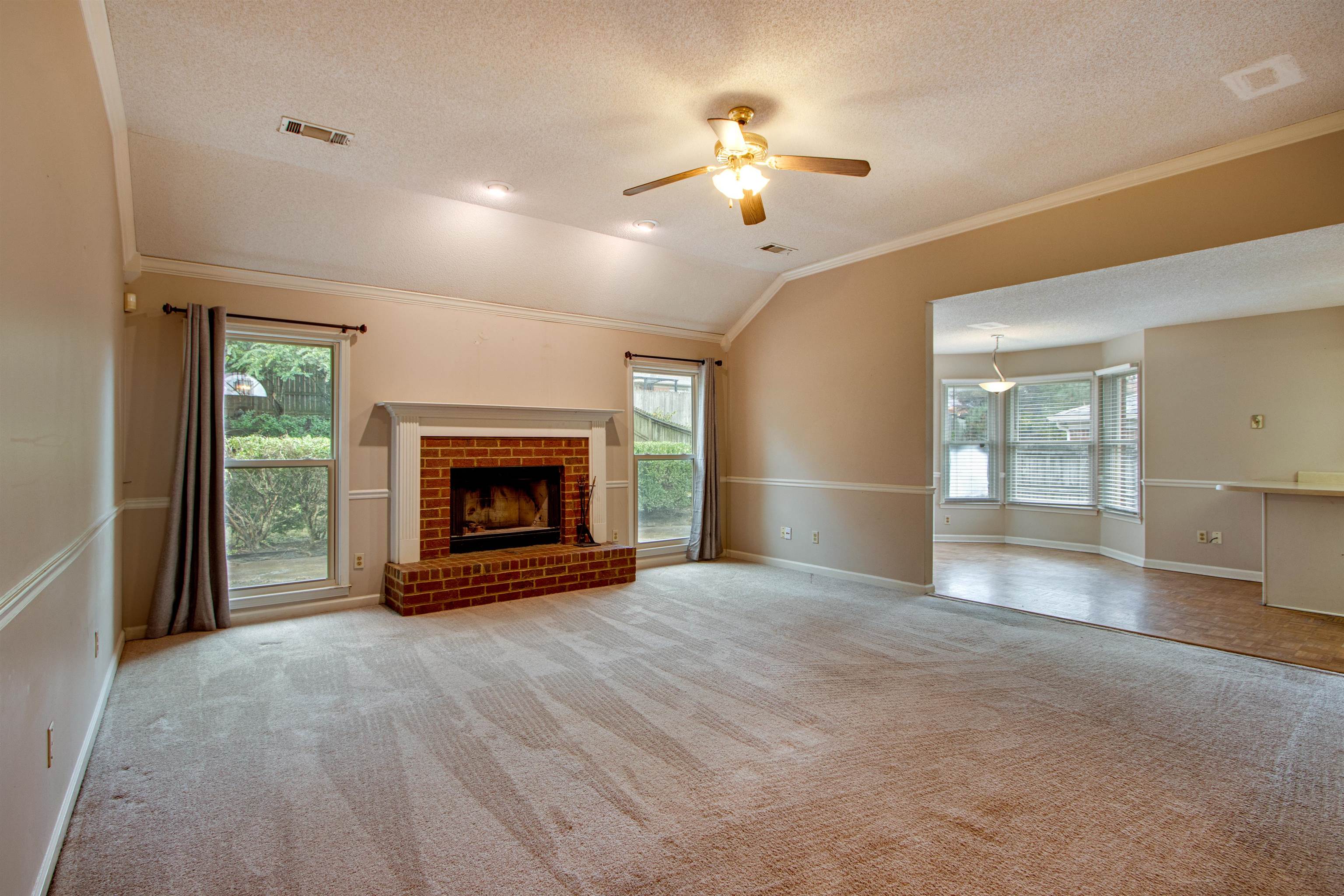 690 Ridge Fall Drive Memphis, TN 38018 - Photo 6 of 28 a view of an empty room with a fireplace and a window