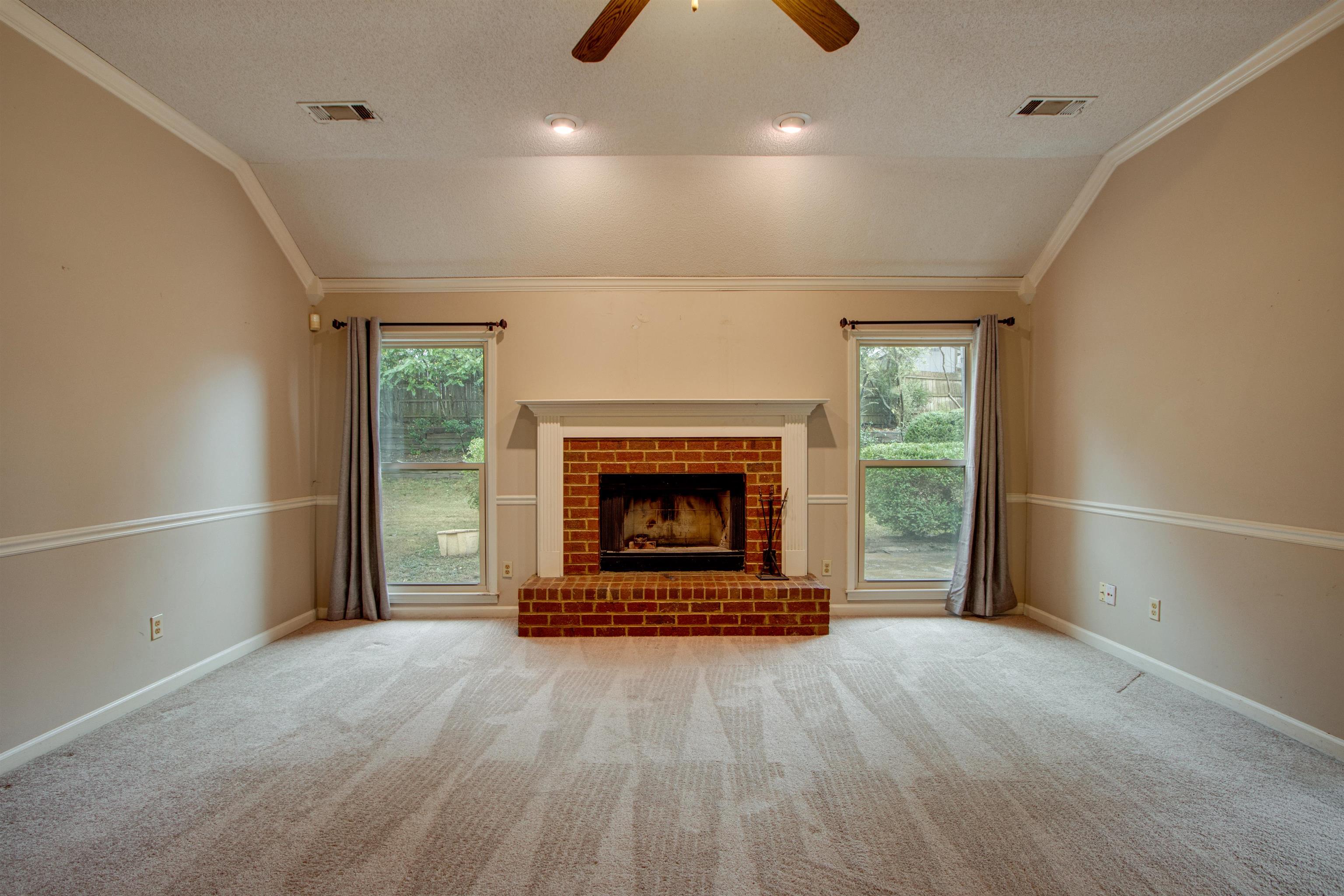 690 Ridge Fall Drive Memphis, TN 38018 - Photo 7 of 28 an empty room with fireplace and window