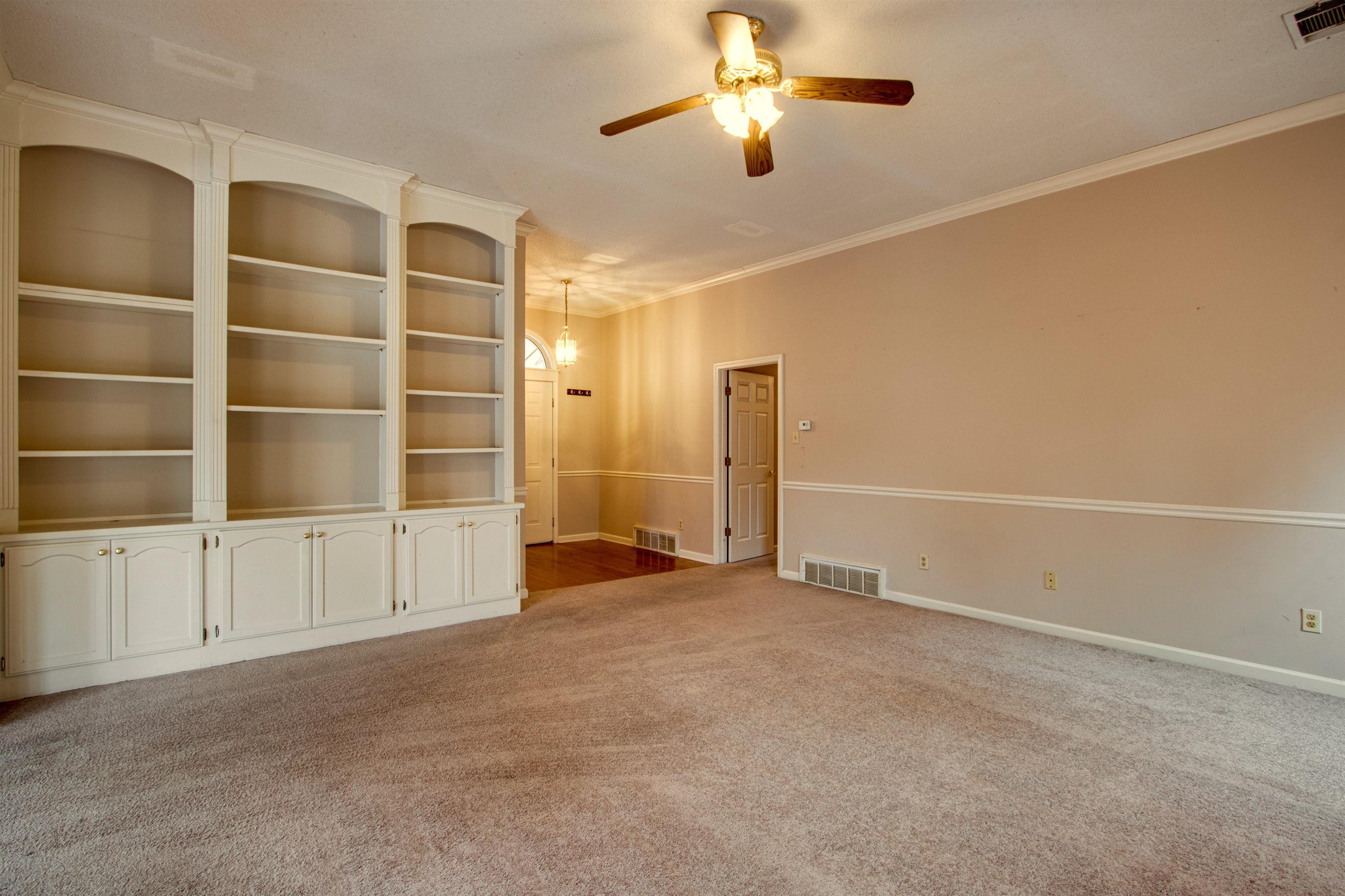 690 Ridge Fall Drive Memphis, TN 38018 - Photo 9 of 28 an empty room with cabinet and windows