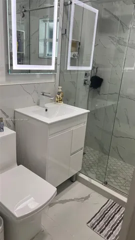 a bathroom with a sink toilet and shower