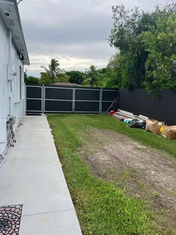 a view of a backyard with swimming pool