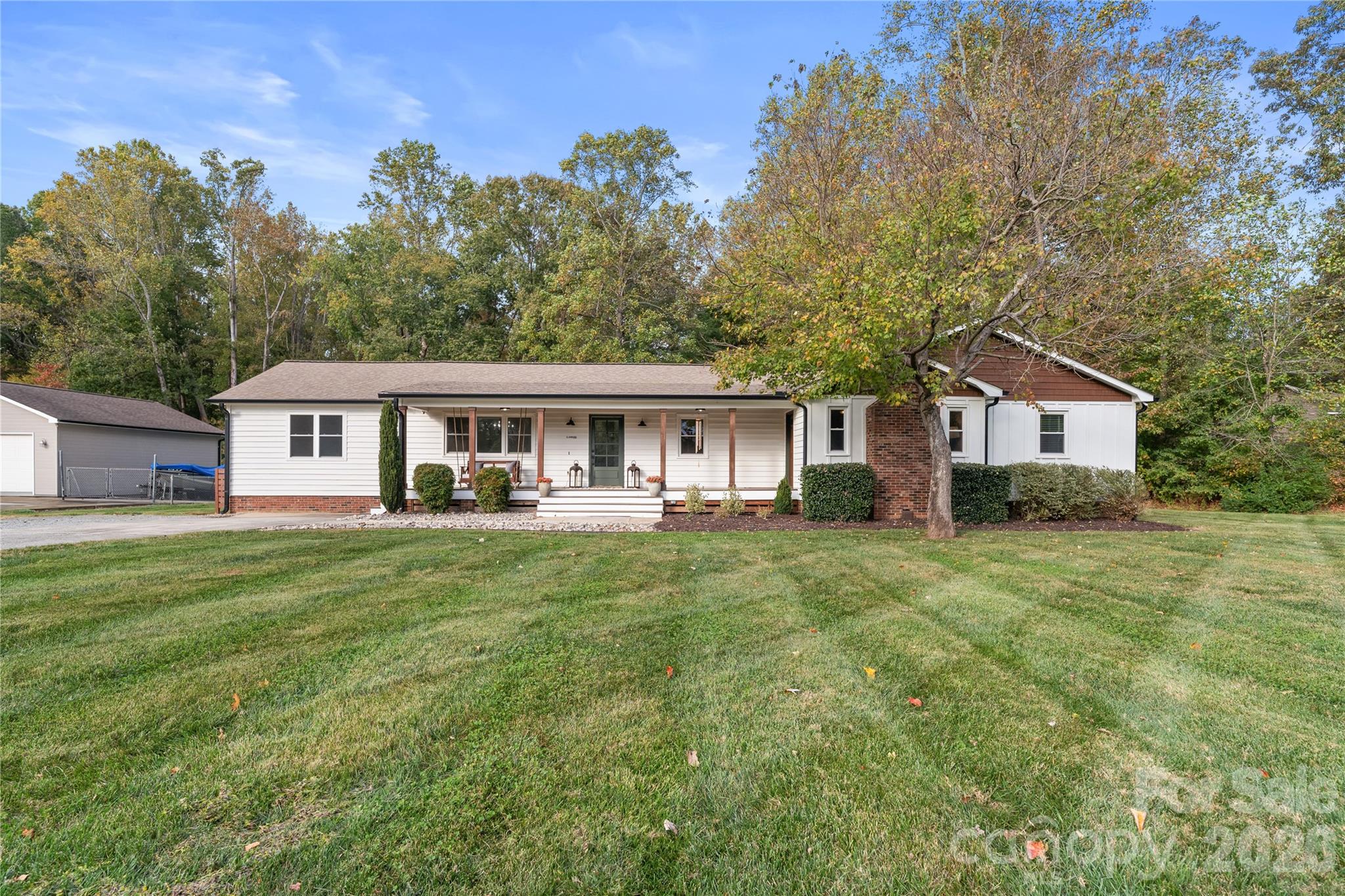 1335 Blacksnake Road Stanley, NC 28164 - Photo 3 of 31 a front of a house with a garden