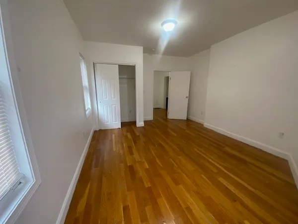 a view of a room with wooden floor and brick walls