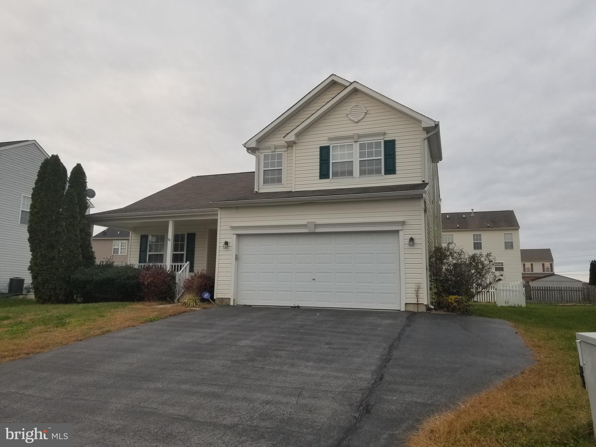 98 Thomas Harmon Drive Camden, DE 19934 - Photo 1 of 21 a front view of a house with a yard and garage