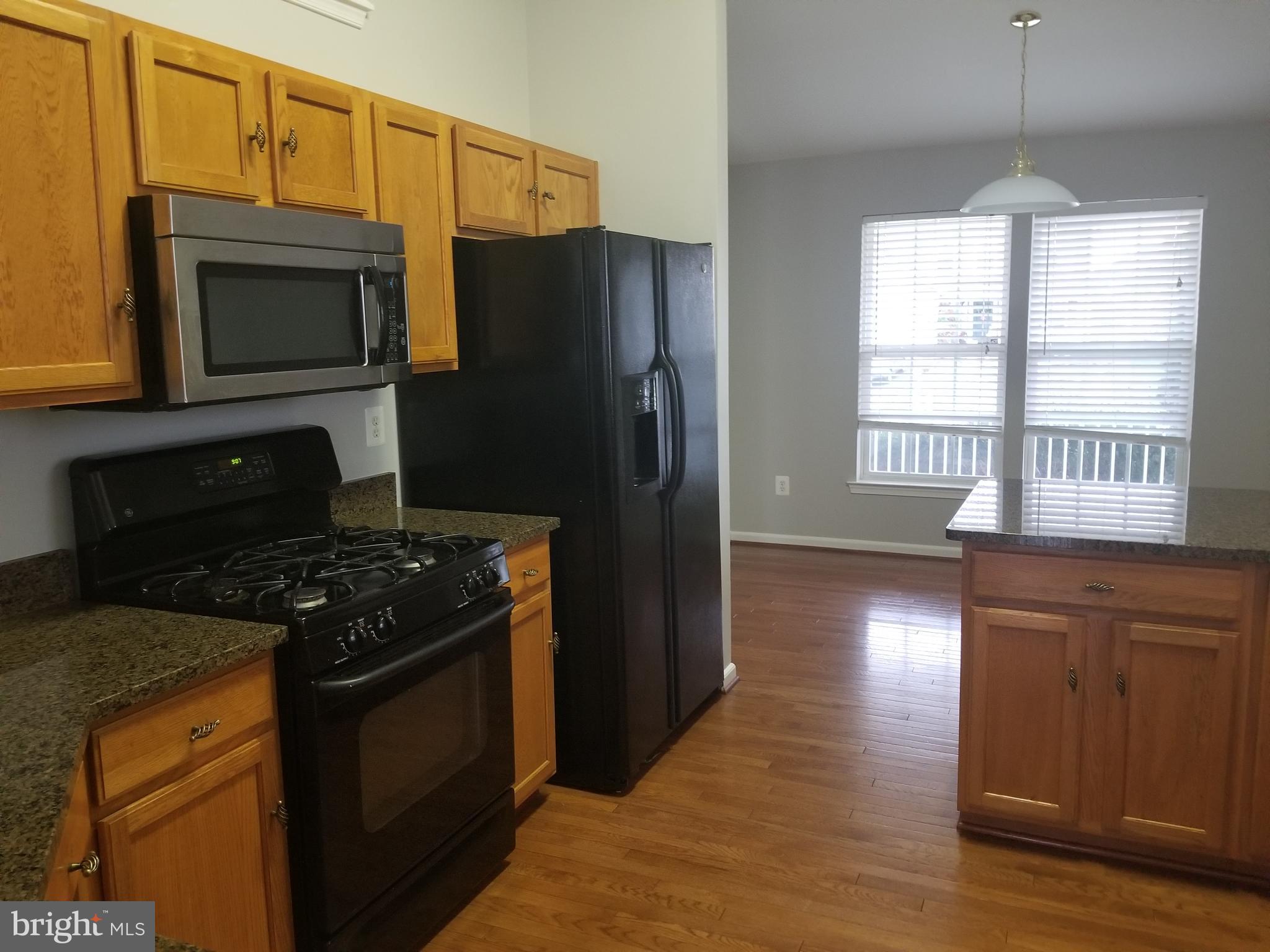 98 Thomas Harmon Drive Camden, DE 19934 - Photo 5 of 21 a kitchen with stainless steel appliances granite countertop a refrigerator stove and microwave