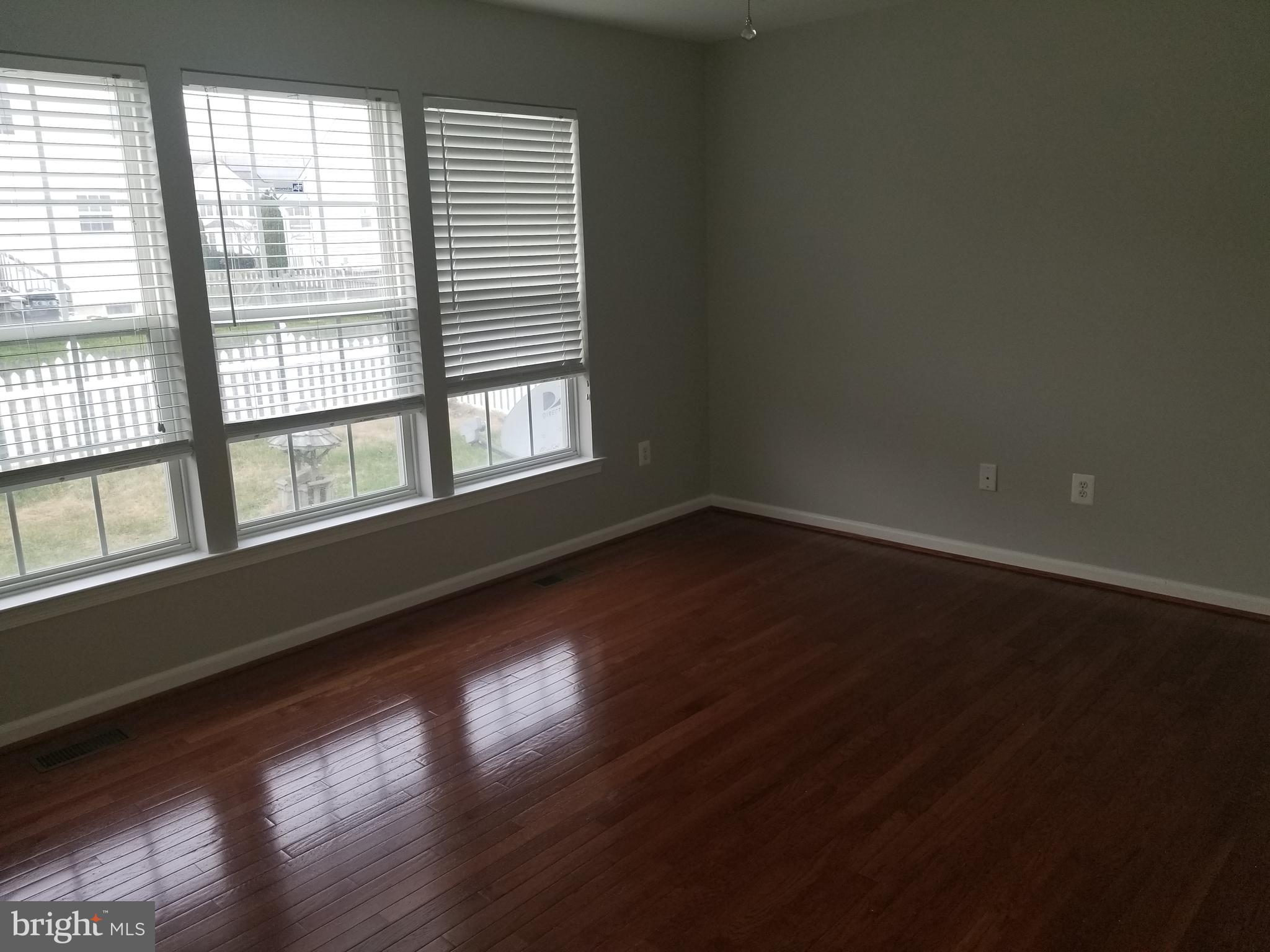 98 Thomas Harmon Drive Camden, DE 19934 - Photo 8 of 21 a view of an empty room with wooden floor and a window