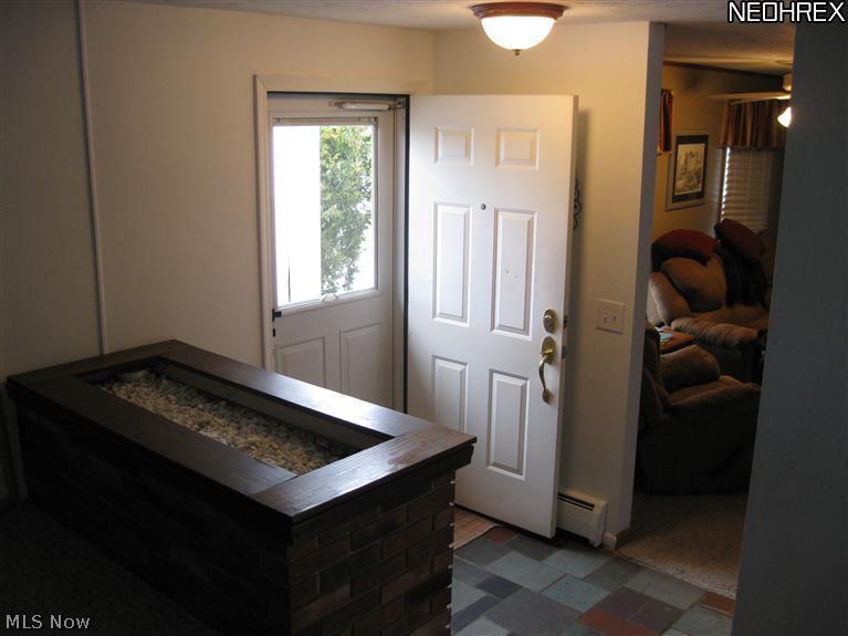 11486 Chillicothe Road Chesterland, OH 44026 - Photo 9 of 13 The foyer has a slate floor and there is a brick planter dividing it from the Living Room. Very open and sunny