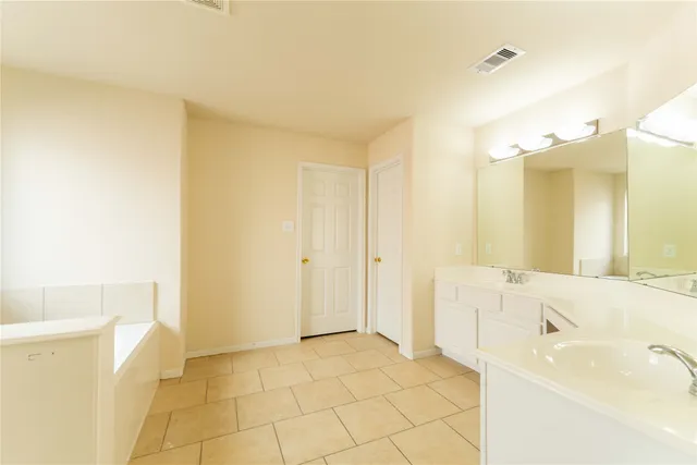 a bathroom with a tub sink and a mirror