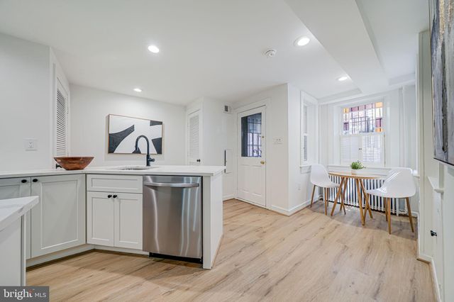 a view of kitchen with wooden floor and electronic appliances