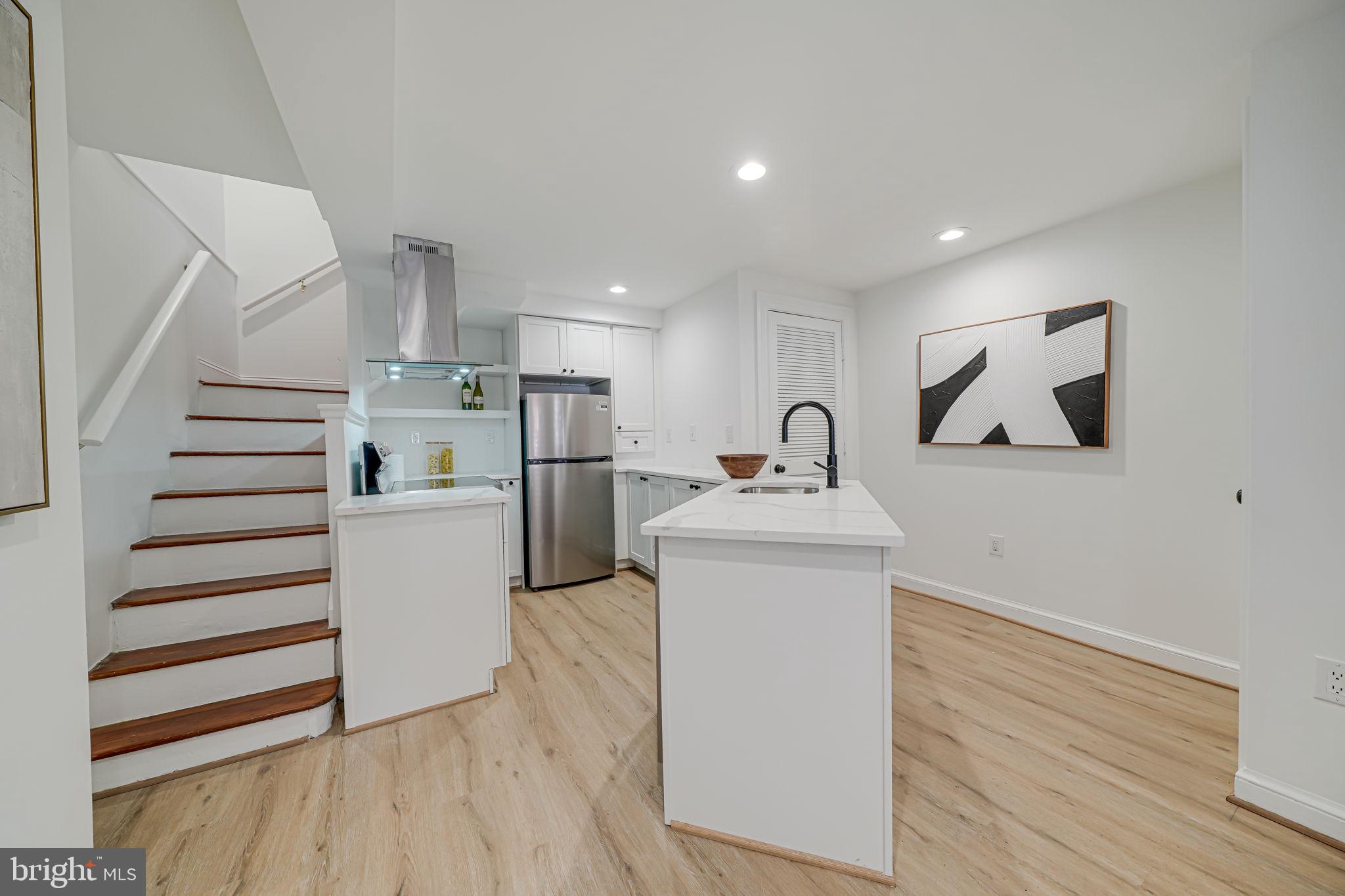 106 3rd Street Northeast Washington, DC 20002 - Photo 15 of 63 a view of kitchen with wooden floor and electronic appliances
