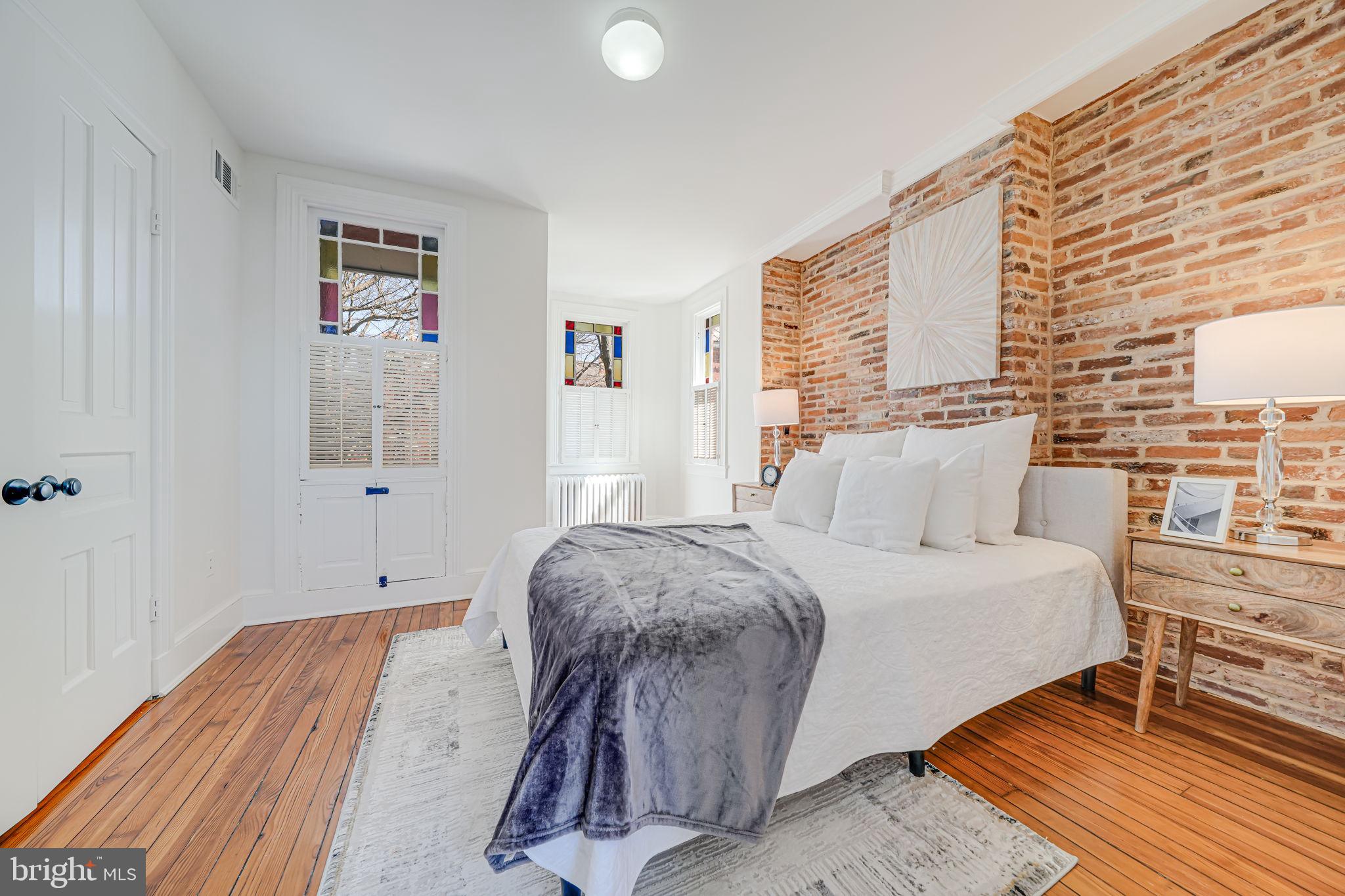 106 3rd Street Northeast Washington, DC 20002 - Photo 20 of 63 a bedroom with a bed and wooden floor