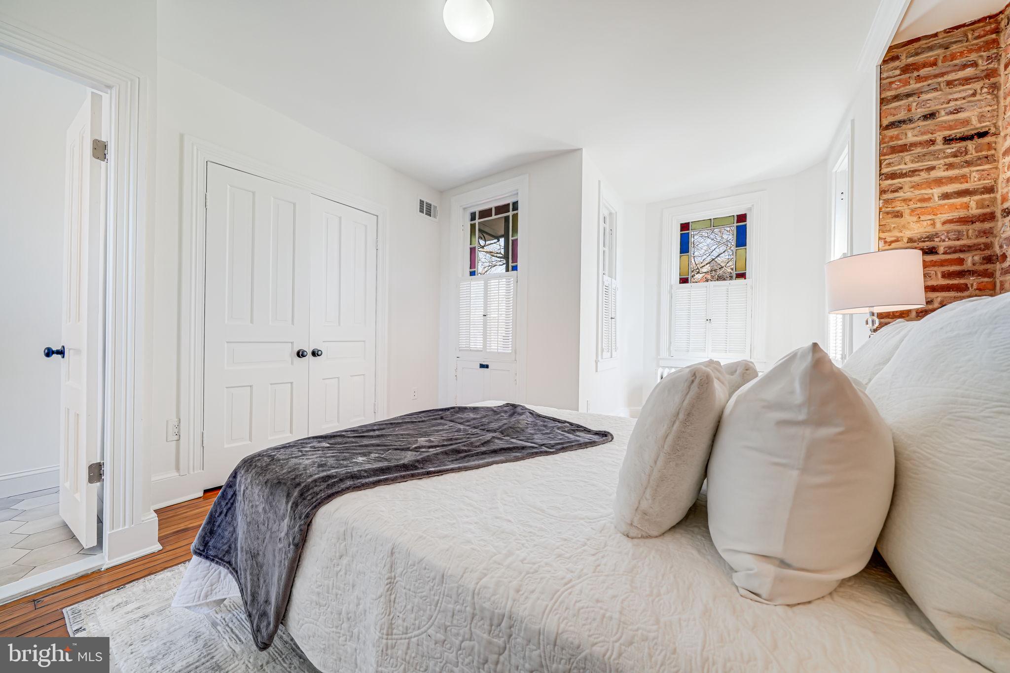 106 3rd Street Northeast Washington, DC 20002 - Photo 23 of 63 a bedroom with a bed and a window
