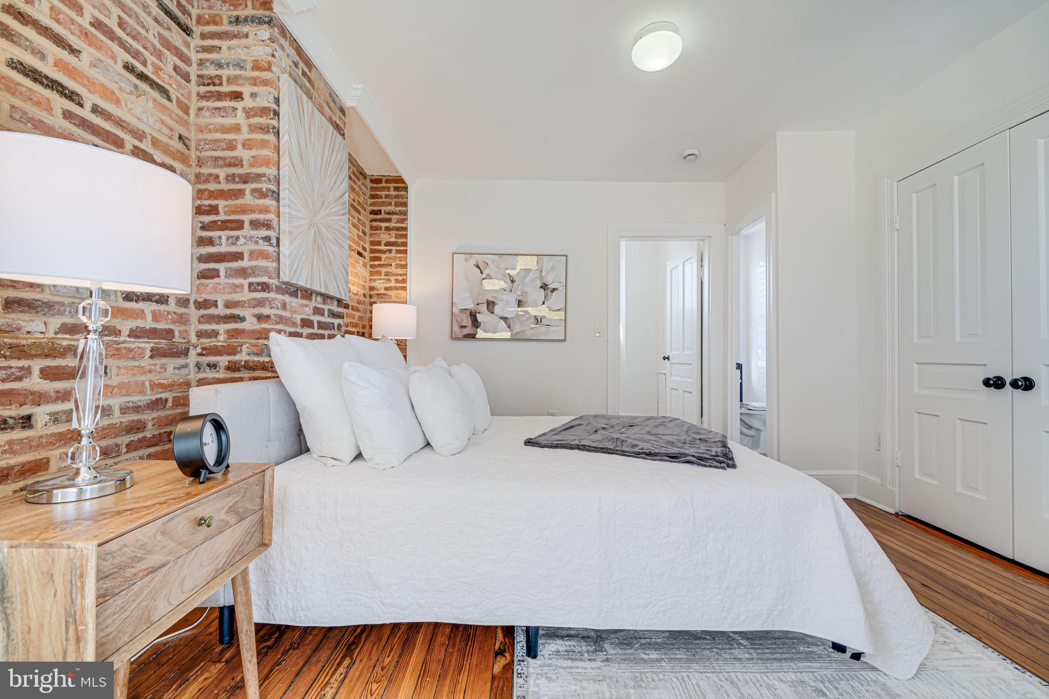 106 3rd Street Northeast Washington, DC 20002 - Photo 26 of 63 a bedroom with a large bed and a window
