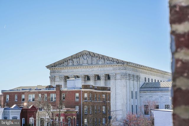 a living room with a couch and a potted plant