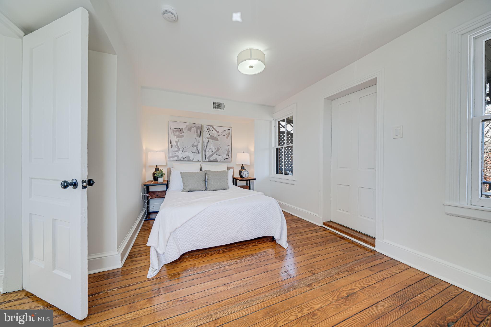 106 3rd Street Northeast Washington, DC 20002 - Photo 36 of 63 a bedroom with a bed and wooden floor