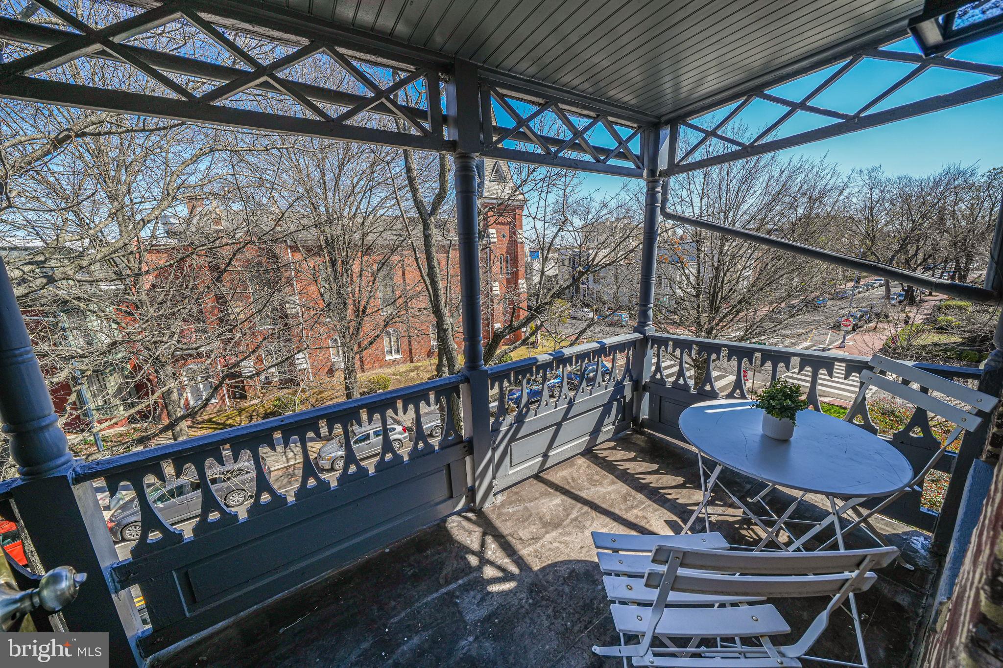 106 3rd Street Northeast Washington, DC 20002 - Photo 42 of 63 a balcony with table and chairs with wooden floor
