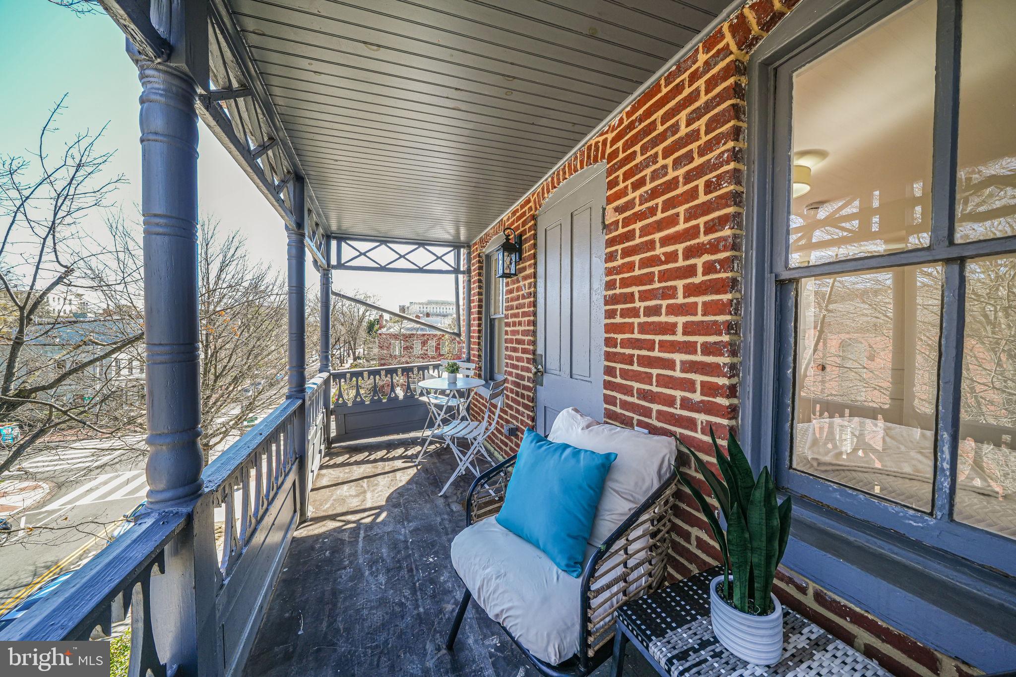106 3rd Street Northeast Washington, DC 20002 - Photo 44 of 63 a balcony with furniture and wooden floor