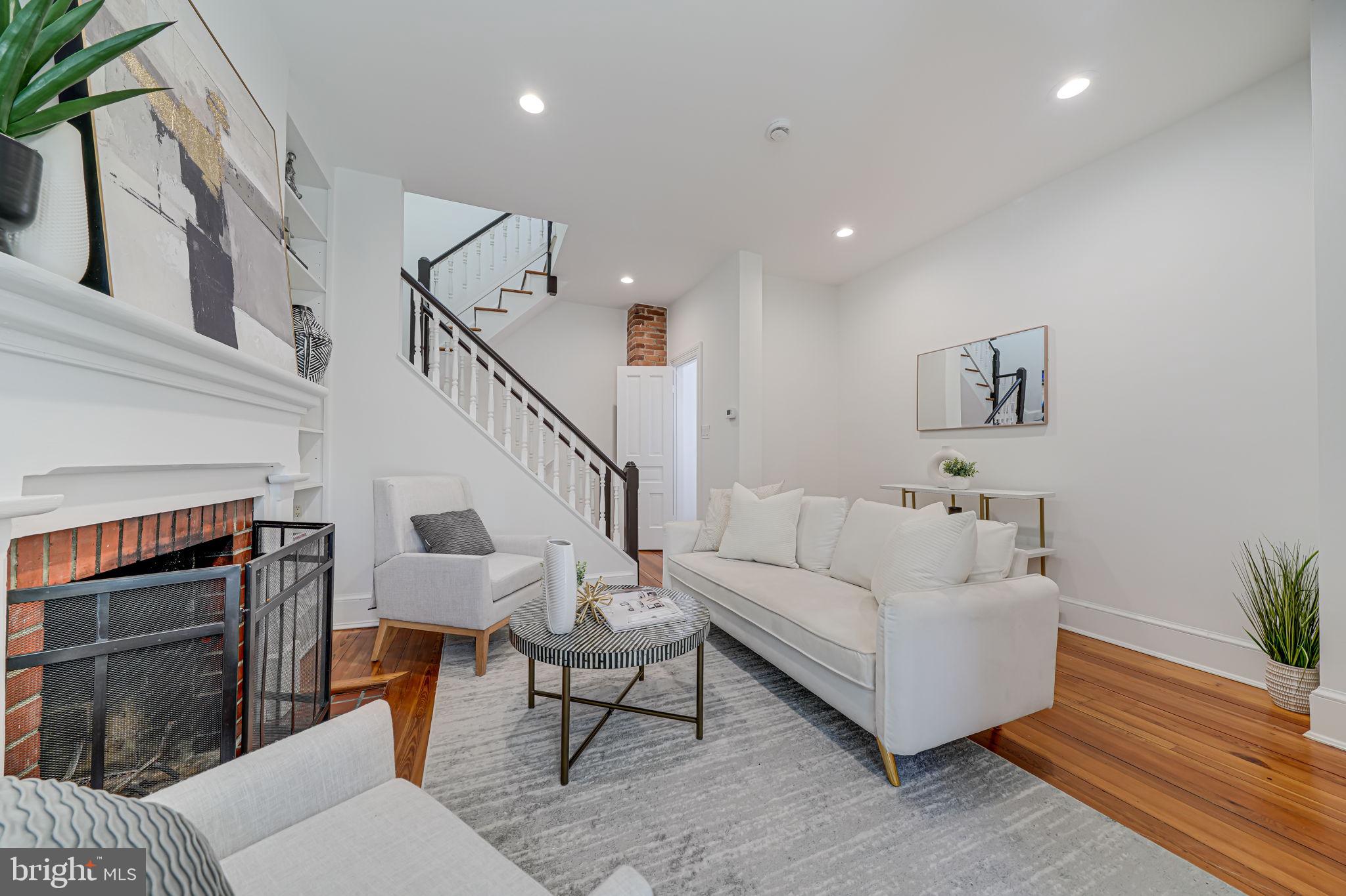 106 3rd Street Northeast Washington, DC 20002 - Photo 8 of 63 a living room with furniture a fireplace and a potted plant