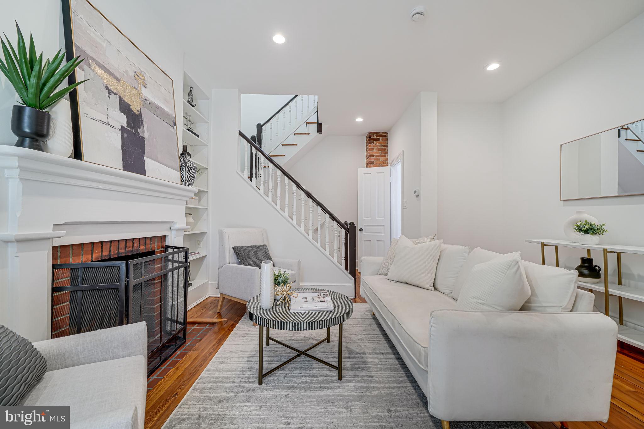 106 3rd Street Northeast Washington, DC 20002 - Photo 9 of 63 a living room with furniture and a fireplace