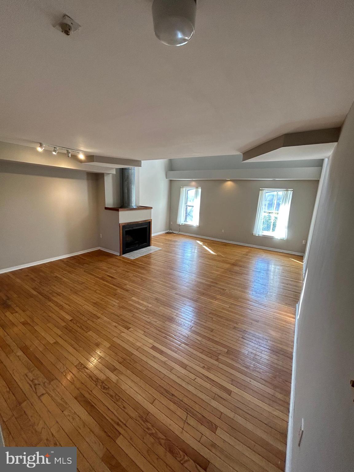 937 Spruce Street Philadelphia, PA 19107 - Photo 66 of 80 an empty room with wooden floor and windows