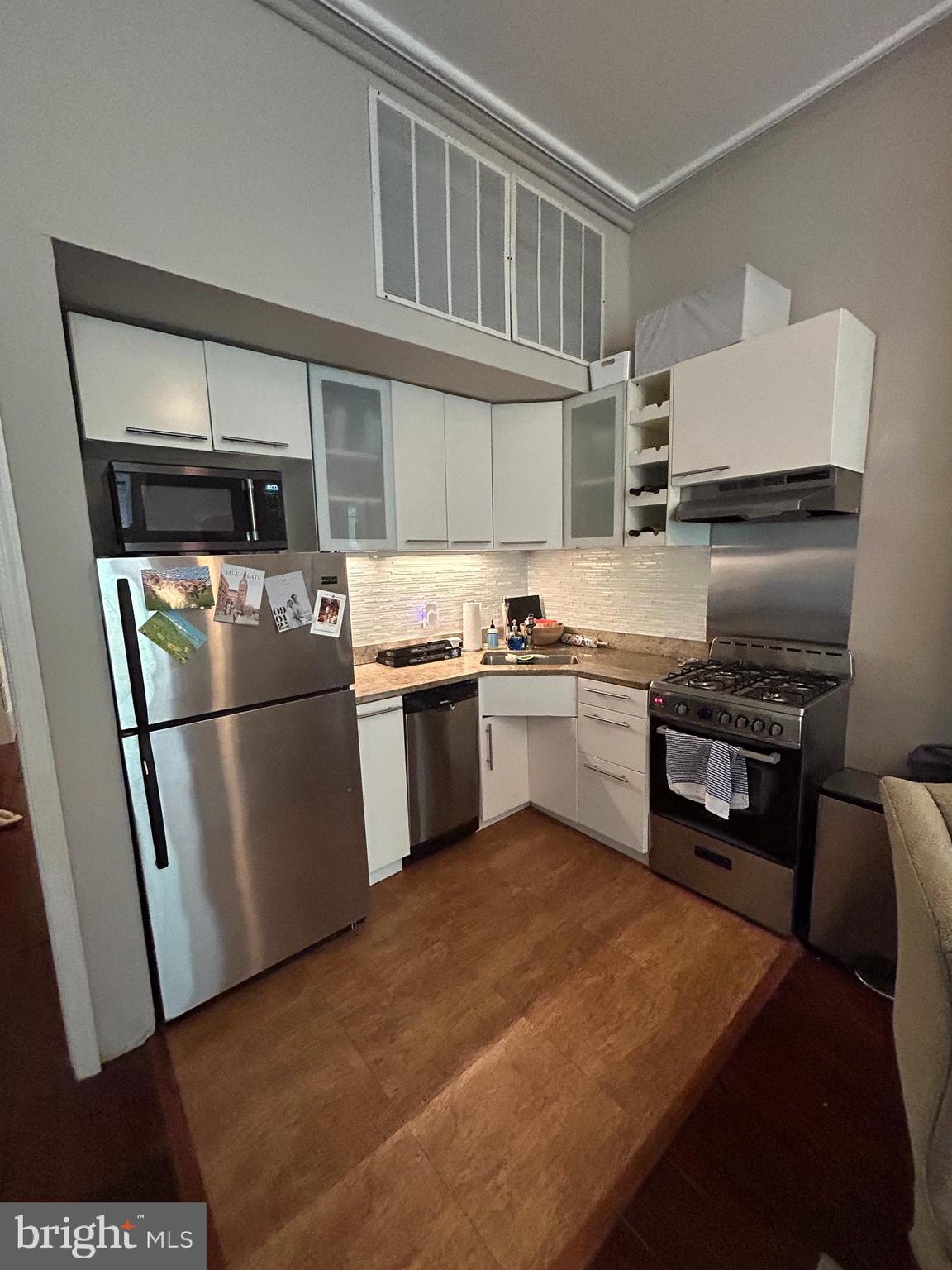 937 Spruce Street Philadelphia, PA 19107 - Photo 10 of 80 a kitchen with stainless steel appliances granite countertop a refrigerator a stove a sink and a microwave