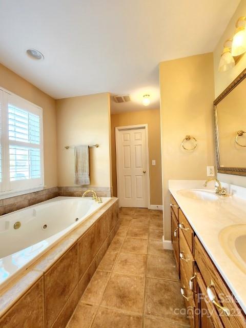 1405 Biggers Cemetery Road Monroe, NC 28110 - Photo 14 of 29 a bathroom with a tub sink and mirror