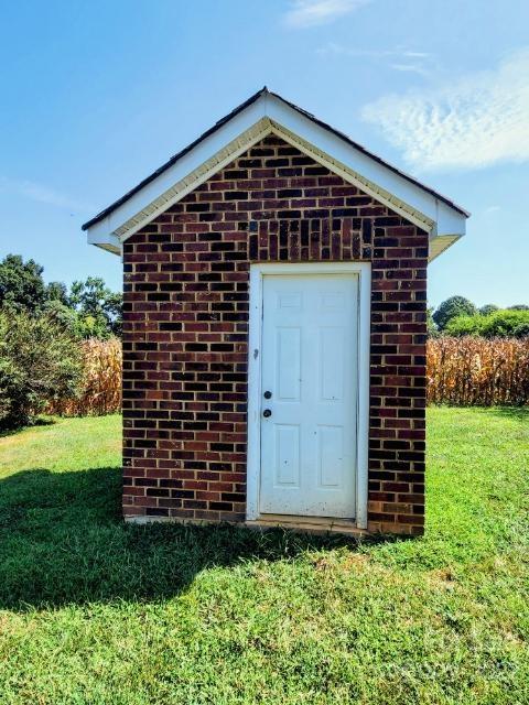 1405 Biggers Cemetery Road Monroe, NC 28110 - Photo 20 of 29 a front view of a house with a yard