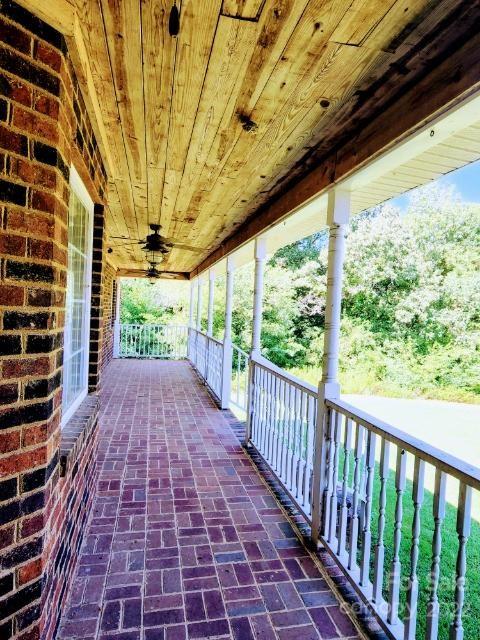 1405 Biggers Cemetery Road Monroe, NC 28110 - Photo 5 of 29 a view of a porch with wooden floor and outdoor space
