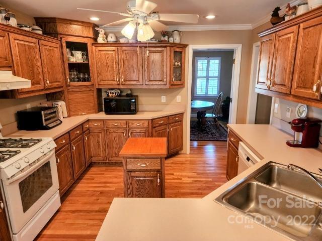 1405 Biggers Cemetery Road Monroe, NC 28110 - Photo 9 of 29 a kitchen with stainless steel appliances granite countertop a stove a sink and a microwave