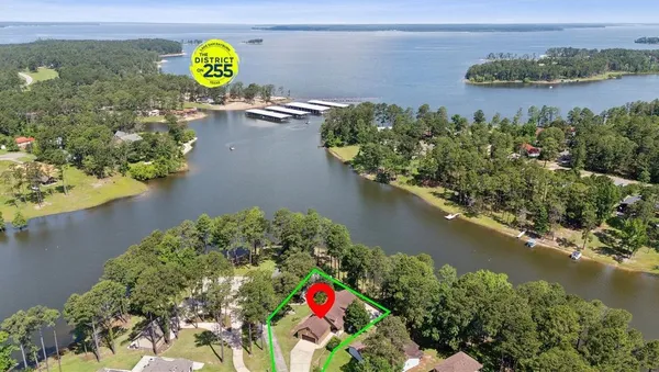 an aerial view of a house with a lake view