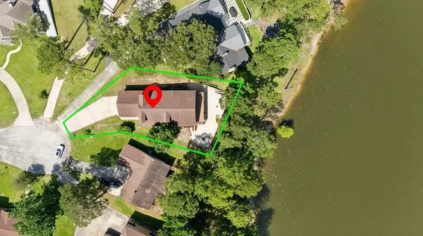 an aerial view of a house with a yard and garden space