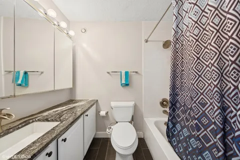 a white toilet sitting next to a bathroom sink