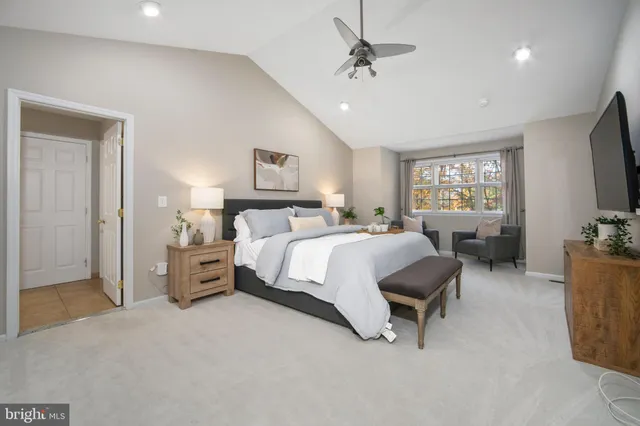 a spacious bedroom with a bed and a window