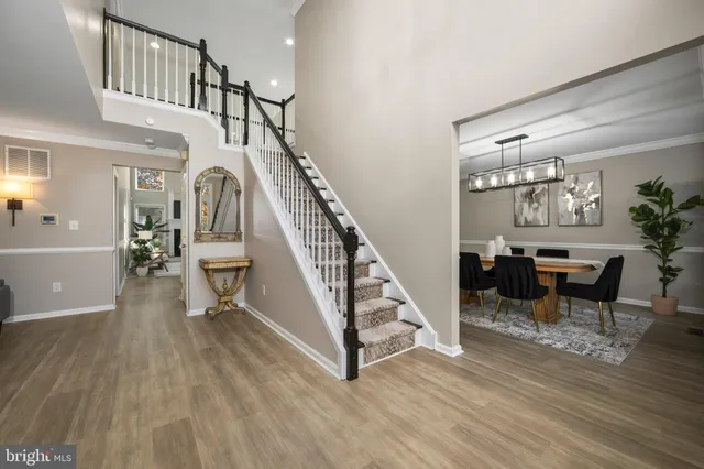 a view of entryway and hall with wooden floor