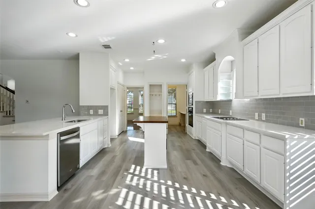 a spacious bathroom with a vanity mirror and a bathtub