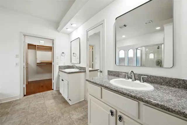 a bathroom with a tub a sink and a shower