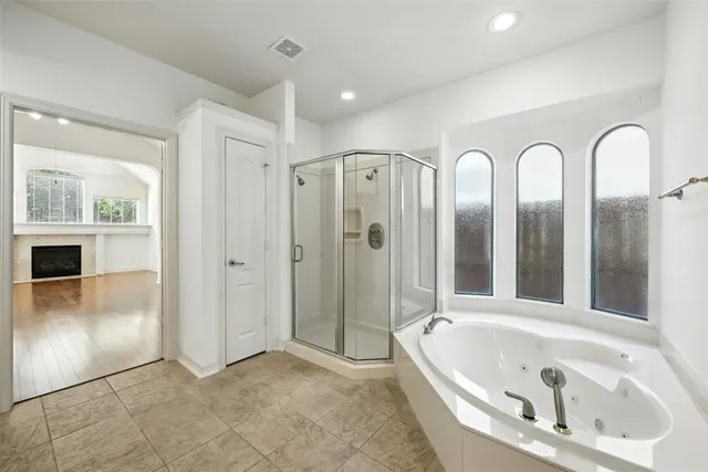 a bathroom with a bathtub and shower