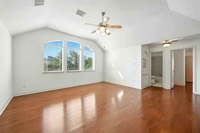 a view of an empty walk in closet with wooden floor