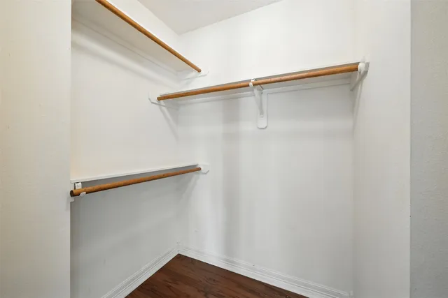 a view of a hallway with windows and entryway