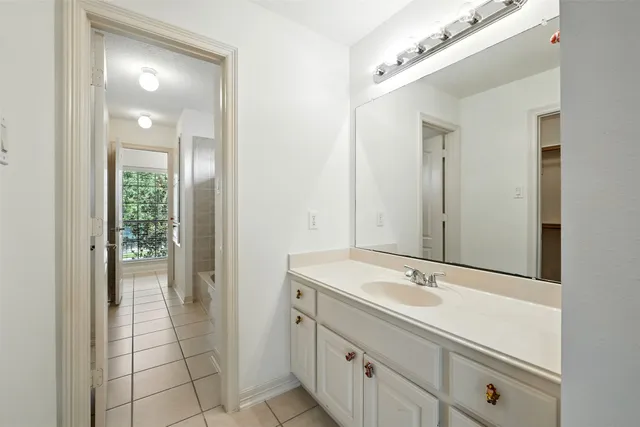 an empty room with wooden floor and chandelier fan