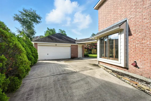 a front view of a house with a yard and potted plants