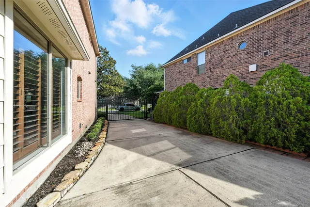 a view of a house with a big yard and large tree