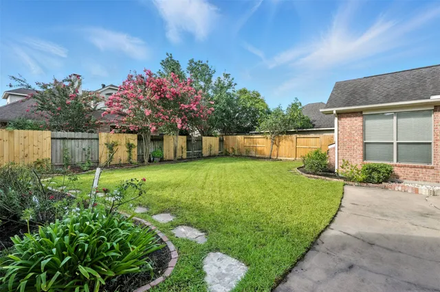 a front view of a house with a garden and yard