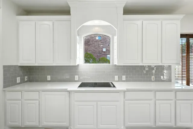 a large kitchen with stainless steel appliances lots of counter space and wooden floor