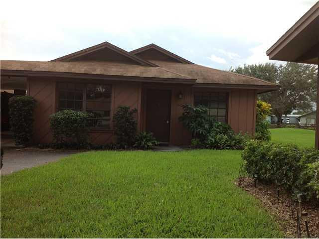 a view of a house with garden and yard