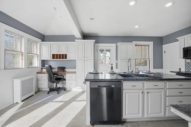 a kitchen with granite countertop a sink and cabinets